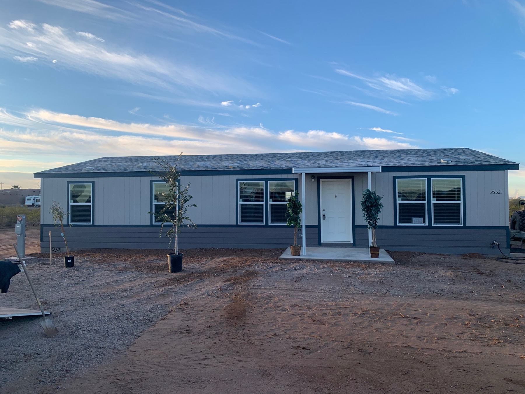 Front of a new home with young trees planted