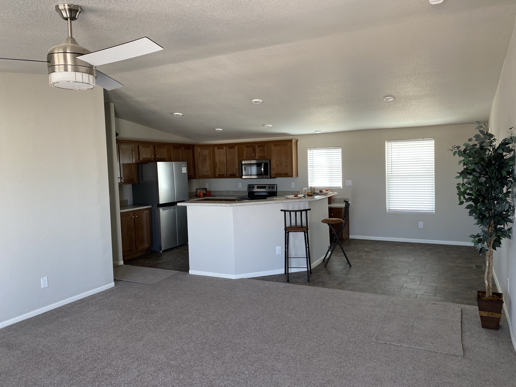Open living room and kitchen with a ceiling fan